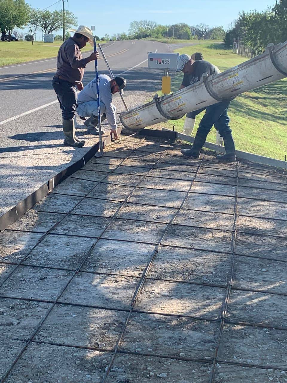 Rebar-set roadside driveway approach at sunset, ready for a concrete pour