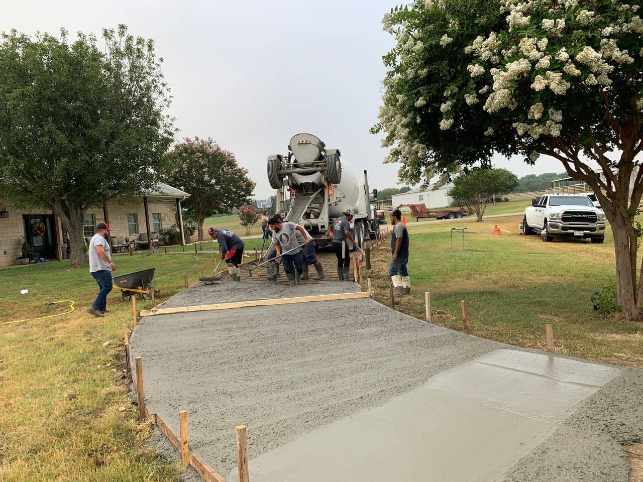 E&D Concrete & Landscape crew finishing a concrete driveway pour on a Highland Lakes property