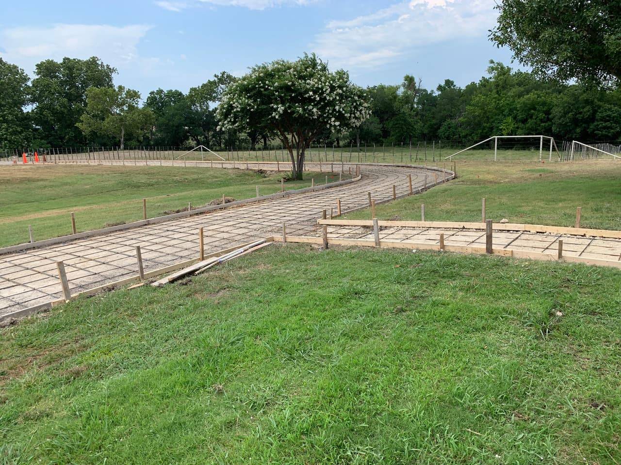 Curved concrete driveway with rebar reinforcement poured on a rural Highland Lakes property