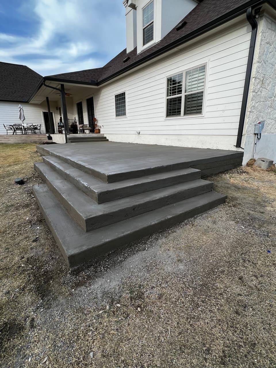 Concrete patio steps poured and finished leading up to a home's back entry