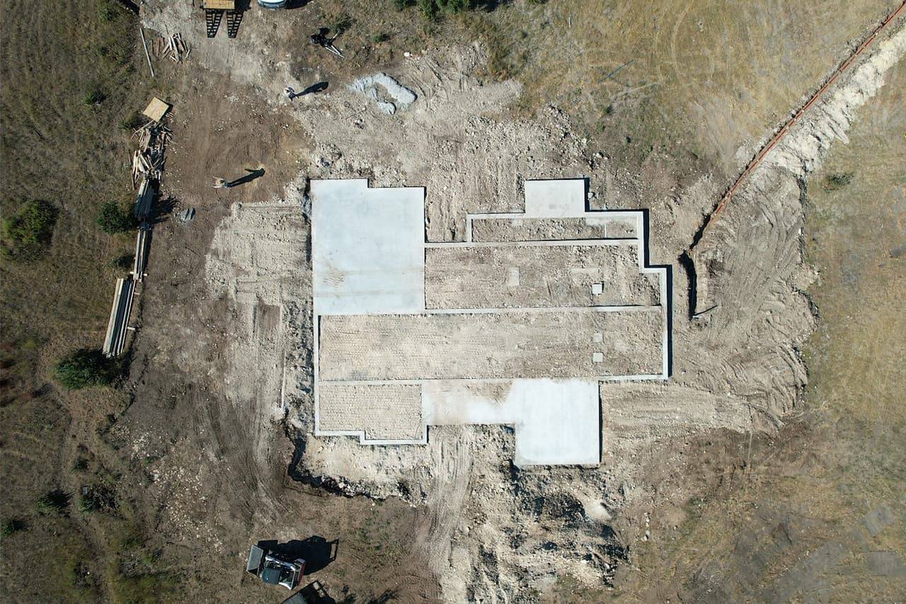 Large reinforced concrete building pad poured and finished, ready for construction to begin