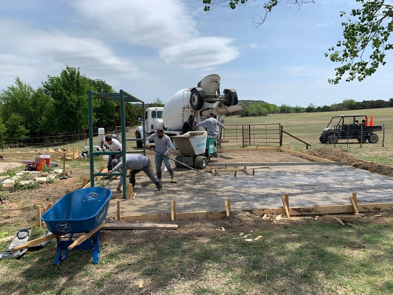Graded rural ranch site with livestock panel gate, prepped ahead of a concrete pour