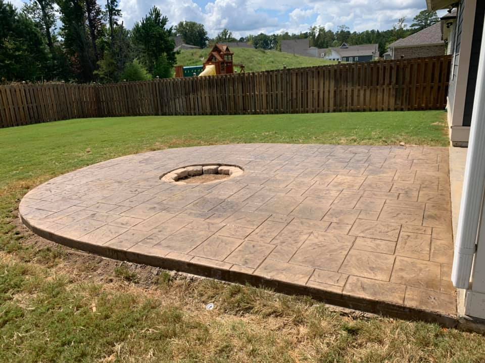 Stamped decorative concrete patio finished with a built-in fire pit ring